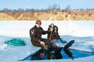 An ice diver setting above the ice