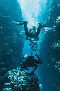Two divers with perfect buoyancy control