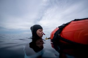 A diver wearing a freediving nose clip