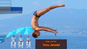 A diver entering water at a dive competition