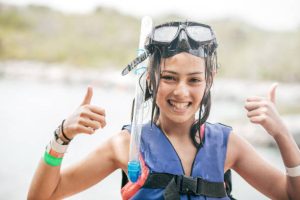 A kid wearing a scuba mask