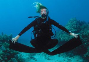 A female scuba diver with good buoyancy control