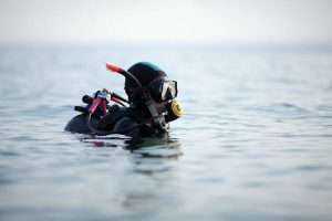 A scuba diver at the surface of the water