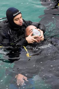 A rescue diver saving another scuba diver