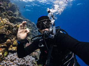 A scuba diver with an ok signal