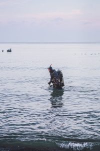 a scuba diver entering the sea