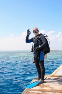 a diver wearing a long wetsuit