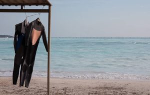 2 hanging wetsuits