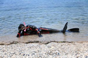a scuba diver wearing a neoprene drysuit