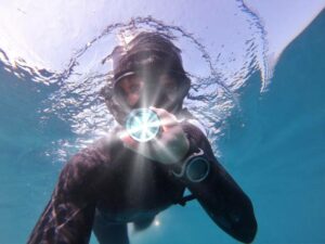 A scuba diver with a compass underwater
